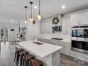 Open-concept kitchen featuring a center island, pendant lighting, and modern appliances at 518 Palmarosa St, Fort Mill, SC 29715