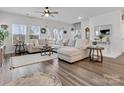 Spacious living room with large sectional couch, lots of natural light, and hardwood flooring at 518 Palmarosa St, Fort Mill, SC 29715