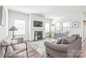 Airy living room featuring a fireplace, neutral-toned furnishings, and hardwood floors at 5367 Turtle Creek Dr, Denver, NC 28037
