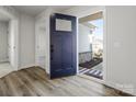 Inviting entryway with stylish dark blue front door, wood-look flooring, and neutral wall colors at 609 Grandiflora Ave, Lancaster, SC 29720