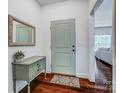 Welcoming foyer with hardwood floors, a decorative table, and a stylish mirror at 6618 Alexander Rd, Charlotte, NC 28270