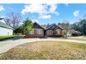 Charming brick home with a well-manicured lawn, a driveway, and mature landscaping at 6618 Alexander Rd, Charlotte, NC 28270