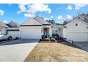 Lovely single-story home with a two-car garage, inviting front porch, and tidy landscaping at 9005 Smokey Hill Ln, Indian Land, SC 29707
