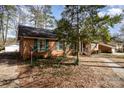 Side view of a traditional brick home with green shutters and mature trees at 1120 Crestview Ave, Salisbury, NC 28144