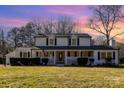 Charming two-story home with a welcoming front porch and well-maintained landscaping at sunset at 1201 Edgefield Ave, Gastonia, NC 28052