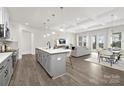 Bright, open-concept living space with a modern island, stainless appliances, and elegant flooring at 134 Montgomery Pl # 708, Mount Gilead, NC 27306
