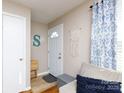 Inviting entryway with a view of the front door, a stylish macrame wall hanging and comfortable seating at 1597 Mcgill St, Rock Hill, SC 29732