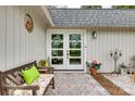 Charming entrance featuring double doors, a bench with bright pillows, and decorative plants at 16137 Tana Tea Cir, Tega Cay, SC 29708