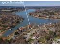 Aerial view of waterfront property with a private dock, lush landscaping, and lake views near 170 W Maranta Rd at 170 W Maranta Rd, Mooresville, NC 28117