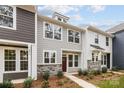 Stylish townhome with neutral siding, stone accents, well-maintained landscaping, and a welcoming entrance at 2013 Near Point Rd # 20, Charlotte, NC 28208