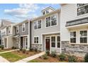 Attractive townhomes with neutral siding, stone accents, manicured landscaping, and inviting entrances at 2013 Near Point Rd # 20, Charlotte, NC 28208