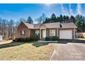 Inviting single-story brick home featuring green shutters and a lush front yard at 2107 Summerfield Cir, Conover, NC 28613
