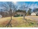 Quaint home with mature trees, a long driveway, and classic brick facade at 2107 Summerfield Cir, Conover, NC 28613