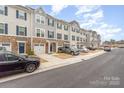 Row of townhomes featuring stone accents, garages, and plenty of parking at 2311 Doby Creek Ln, Charlotte, NC 28262