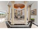Luxurious dining room with ornate columns, chandelier, wall mural and seating for six guests at 249 Blue Heron Dr, Rock Hill, SC 29732