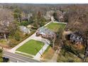 Expansive aerial view of a beautiful home with a large, well-maintained lawn and mature trees at 2701 Sharon Rd, Charlotte, NC 28211