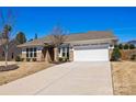 A single story brick home with a two car garage and a well maintained lawn in front of the property at 2914 Hiddenbrook Way, Indian Land, SC 29707