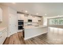 Spacious kitchen with white cabinets, an island, and stainless steel appliances at 4134 Camden Glen Rd, Lancaster, SC 29720