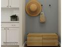 Stylishly decorated entryway featuring white cabinets, a wooden bench and decorative wall hangings at 4138 Camden Glen Rd, Lancaster, SC 29720