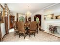 Traditional dining room featuring a chandelier, fireplace, and a large round table at 419 Park Ridge Rd, Albemarle, NC 28001