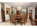 Elegant dining room with crystal chandelier, large windows, and hardwood floors at 419 Park Ridge Rd, Albemarle, NC 28001