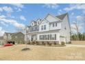 Charming two-story home featuring white siding and dark shutters with a well-maintained lawn at 4604 Howie Ln, Harrisburg, NC 28075
