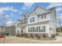 Beautiful two-story home showcasing white siding and dark shutters with well-kept landscaping at 4604 Howie Ln, Harrisburg, NC 28075