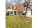 Charming two-story brick and siding home with green shutters, a well-manicured lawn, and an attached two-car garage at 9138 Babbitt Way, Charlotte, NC 28216