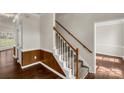 Inviting foyer with classic staircase featuring wood handrails and white spindles leading to the upper level at 9138 Babbitt Way, Charlotte, NC 28216