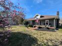 Home showcasing blooming magnolias and American flag, enhancing curb appeal at 101 Sunset Dr, Stanley, NC 28164