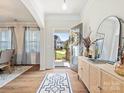 Inviting foyer with wood floors, a stylish console table, and a glimpse of the home's bright interior at 1017 Cheviot Ct, Waxhaw, NC 28173
