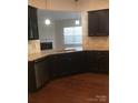 Kitchen featuring granite countertops, stainless steel dishwasher, and pendant lighting above the sink at 113 Burlingame Ct # D, Mooresville, NC 28117