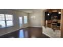 Bright living room featuring hardwood floors, abundant natural light, and an elegant chandelier fixture at 113 Burlingame Ct # D, Mooresville, NC 28117