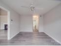 Bedroom with gray walls, fan, and a large closet with hardwood style floors at 12601 Tucker Crossing Ln, Charlotte, NC 28273