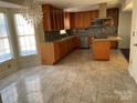 Bright and airy kitchen featuring granite countertops, stainless steel appliances and a large island at 12662 Woodside Falls Rd, Pineville, NC 28134