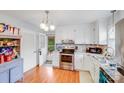 Bright kitchen featuring white cabinetry, stainless steel appliances, granite countertops, and backyard access at 1377 Buckingham Ave, Gastonia, NC 28054