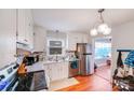 Well-lit kitchen with stainless steel appliances, white cabinets, and a modern backsplash at 1377 Buckingham Ave, Gastonia, NC 28054