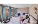 Comfortable living room with a large window overlooking the front yard, a white couch, and stylish decor at 1377 Buckingham Ave, Gastonia, NC 28054