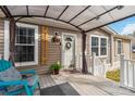 Cozy front porch featuring a seating area, awning, wood accents, and a welcoming front door at 1804 Tom Joye Rd, Clover, SC 29710