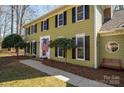 A view of the home with traditional windows and manicured lawn with a walkway at 4301 Old Forge Dr, Gastonia, NC 28056