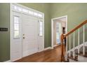 The entryway boasts hardwood floors, a staircase, and natural light streaming through sidelight windows at 4301 Old Forge Dr, Gastonia, NC 28056