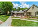 Beautiful backyard with a stone walkway, lush landscaping, and a tranquil patio with outdoor seating at 4531 Montibello Dr, Charlotte, NC 28226