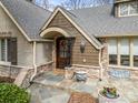Charming front entrance featuring a wooden door, brick accents, and a welcoming arched porch at 4531 Montibello Dr, Charlotte, NC 28226