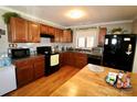 Traditional kitchen features wood cabinets, laminate countertops, and includes black appliances at 508 Bessemer City Rd, Gastonia, NC 28052