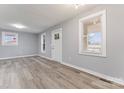 Spacious open-concept living room featuring new flooring, fresh paint, and natural lighting at 5329 Southampton Rd, Charlotte, NC 28217