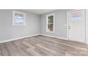Bright living room featuring fresh paint, luxury vinyl plank flooring, and modern windows at 5329 Southampton Rd, Charlotte, NC 28217