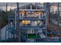 Multi-level lake house featuring expansive decks and charming outdoor living spaces with serene wooded views at 547 Lake Shore Dr, Norwood, NC 28128