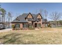 Brick home featuring multiple gables, black shutters, with grass yard and lake view at 5628 Creole Rd, Clover, SC 29710