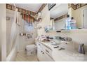 Dated bathroom with a combination tub/shower, hexagon tile flooring, a floral motif border and plenty of counter space at 607 Dick St, Albemarle, NC 28001