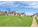 Exterior view of a brick home with an expansive lawn, showcasing a well-maintained landscape at 609 Rosemore Pl, Rock Hill, SC 29732